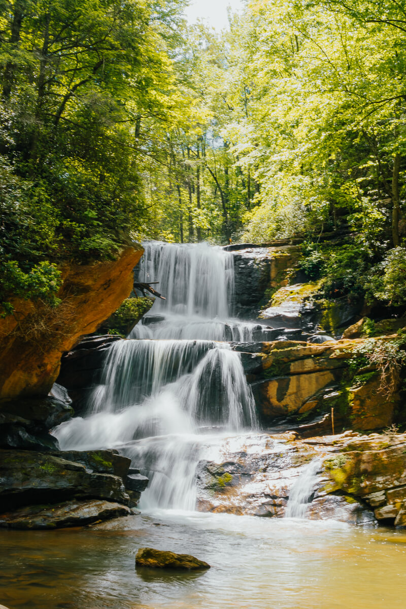 View from the base of Little Bradley Falls in Saluda, NC on a sunny, summer day