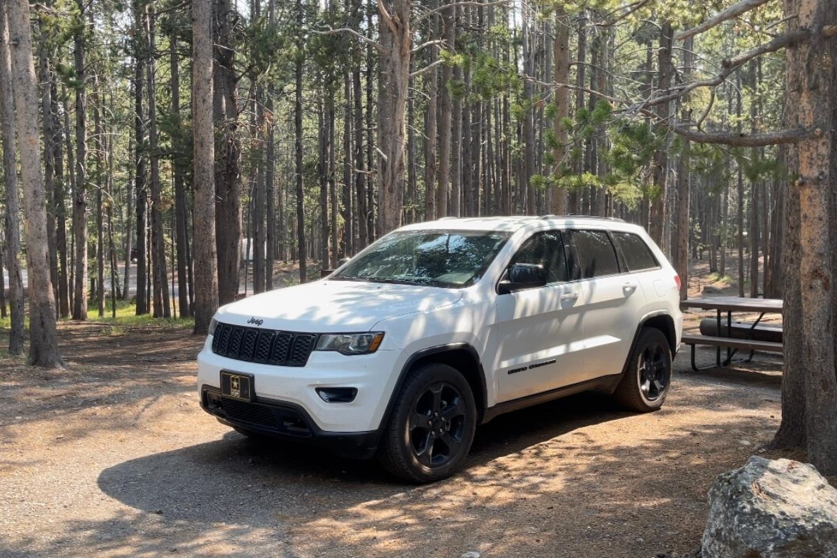 White Jeep Grand Cherokee parked in a campsite at Canyon Campground in Yellowstone National Park