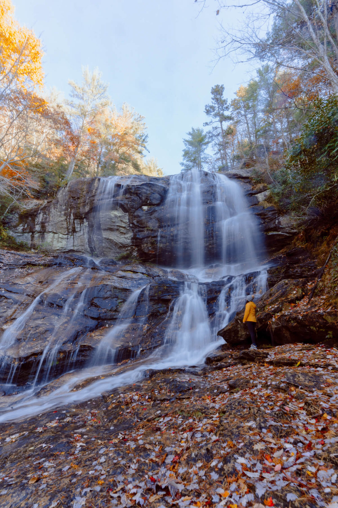 Woman admiring the middle waterfall at Glen Falls in Highlands, NC