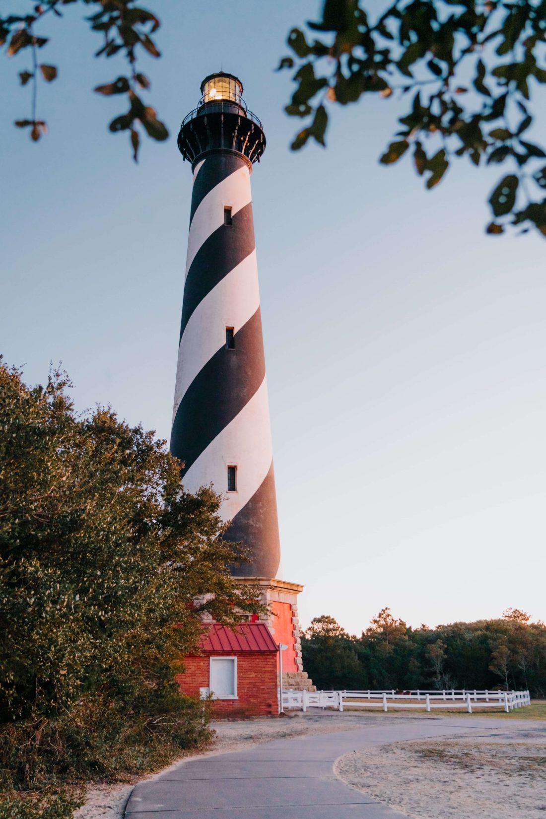 Close up of Cape Hatteras Lighthouse at sunset with its light flashing