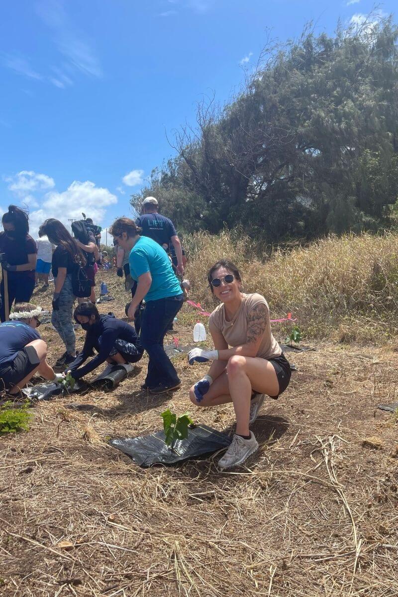 Woman planting native species at a state park in Hawaii