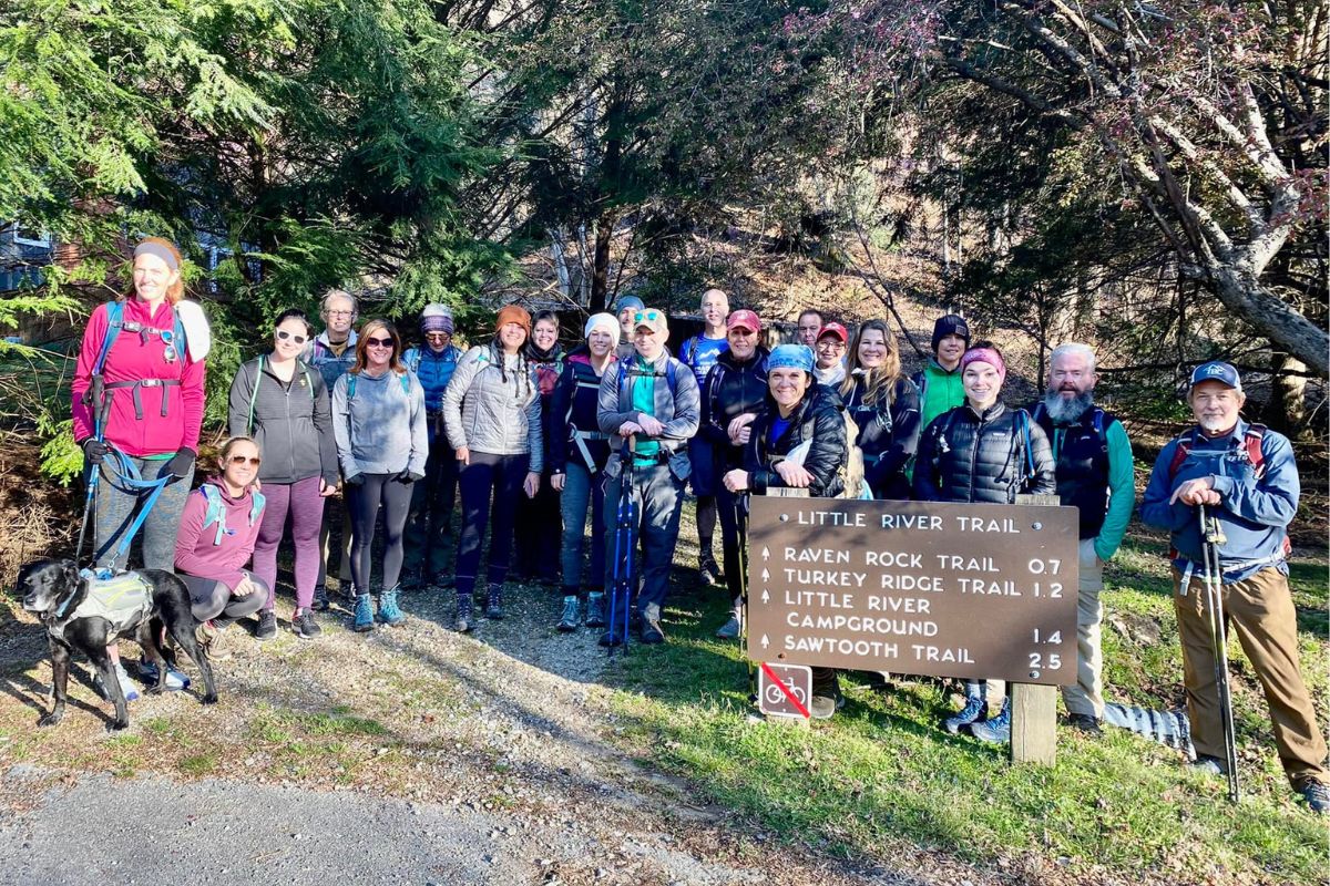 Group of 21 hikers standing together posing for a photo